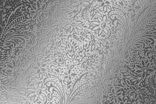 A silver wallpaper with a floral pattern.